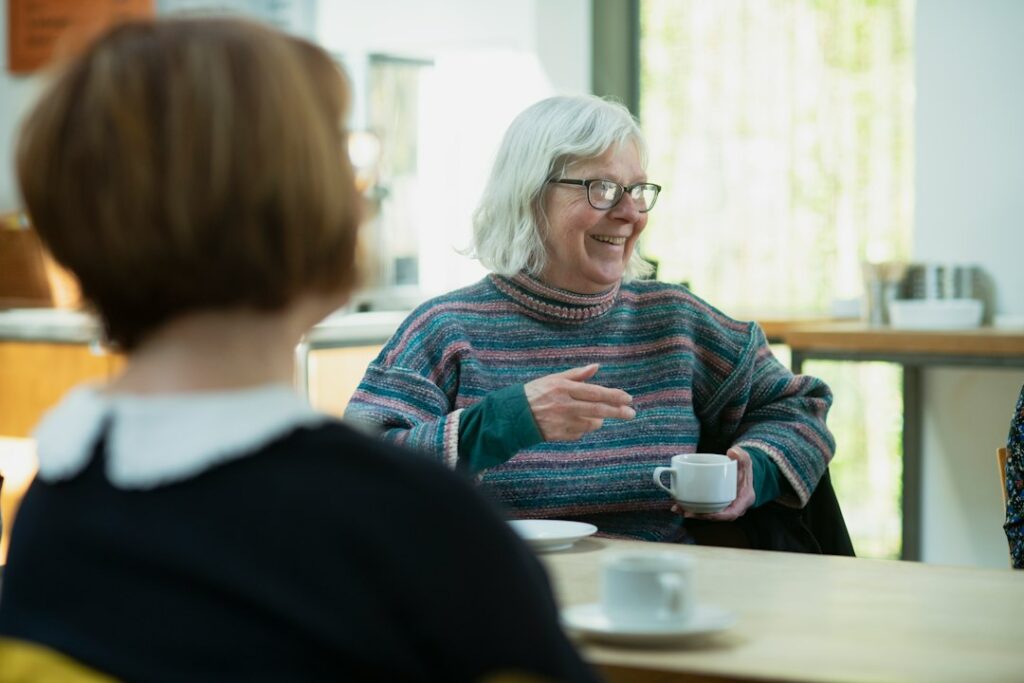 Two adults having a warm conversation, illustrating hearing accessibility and human connection